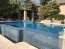 Perimeter overflow pool with water at decking level.